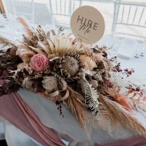 A stunning pink long floral arrangement perfect for adorning wedding arbours and bridal tables."