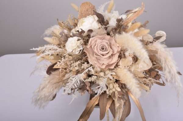 top view. centrepiece. round table. earthy nude roses, warm tones, dried and preserved flowers. hire item