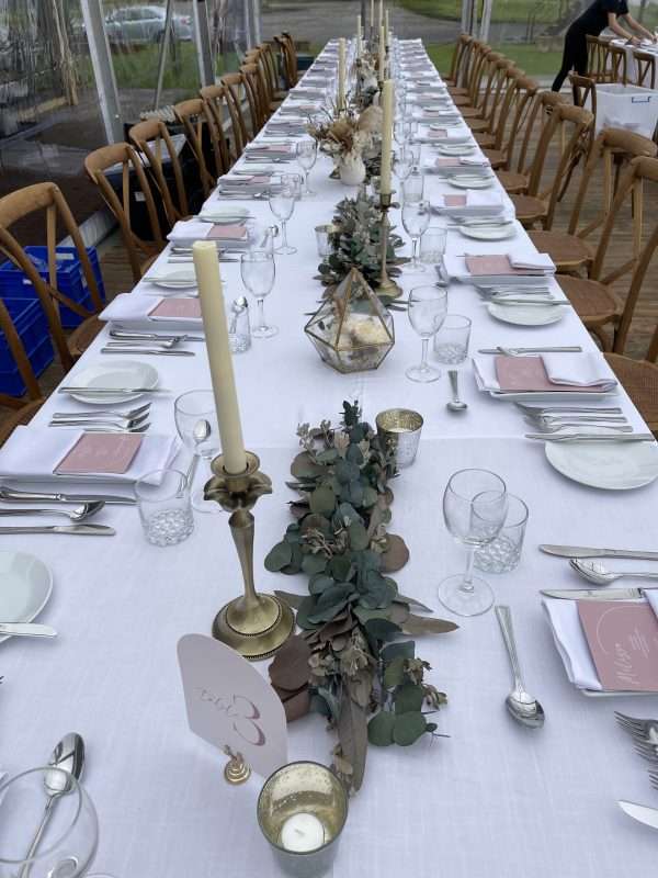 long table styling. Candlesticks tealights and Eucalyptus garland pieces. preserved HIRE eucalyptus table runners