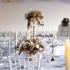 Reception HIRE floral decorations. dried and preserved flowers. tall and low centrepieces. Round tables. gold styling