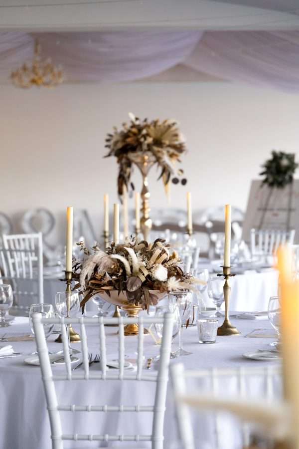 Reception HIRE floral decorations. dried and preserved flowers. tall and low centrepieces. Round tables. gold styling