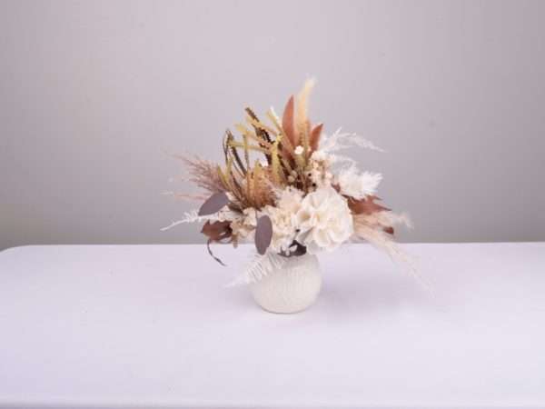 small petite posy , flower bunch, in vase. Earthy natural tones of ivory nude browns, Hire item. dried and preserved flowers