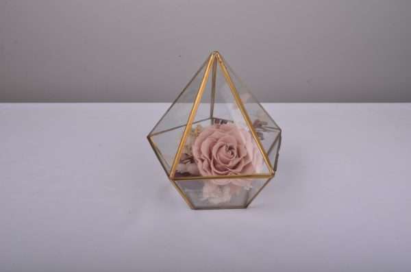 small pink hire arrangement in terrarium gold frame. pink preserved rose.