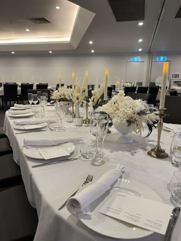 white wedding reception centrepiece. long wedding table flowers. white, green and gold wedding reception table centrepieces. gold candlesticks