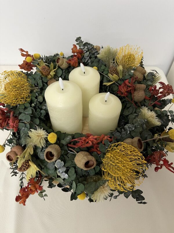 Bright Native HIRE wreath with candles. centrepiece. Pincushions, yellow, red kangaroo paw, gumnuts