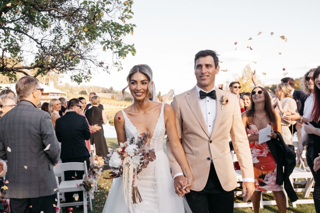 Gorgeous couple after ceremony, neutral warm flowers